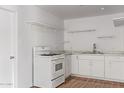 Newly remodeled kitchen with white shaker cabinets and modern appliances at 8215 E 2Nd Ave, Mesa, AZ 85208