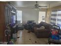 Living room with tiled floor and brown couch at 8501 W Vernon Ave, Phoenix, AZ 85037