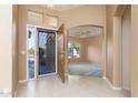 Bright entryway with tiled floors and an ornate iron door at 9007 E Emerald Dr, Sun Lakes, AZ 85248