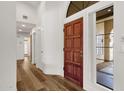 Bright entry hall with wood flooring and an interior door at 10508 E Mission Ln, Scottsdale, AZ 85258