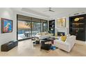 Bright living room with fireplace, built-in shelving, and multiple seating areas at 11127 E Mirasol Cir, Scottsdale, AZ 85255