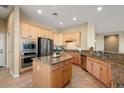 Eat-in kitchen with island, stainless steel appliances, and wood cabinetry at 13148 W Figueroa Dr, Sun City West, AZ 85375