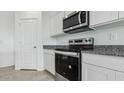 Stainless steel stove and microwave in a modern kitchen at 1543 E Lardner Dr, Casa Grande, AZ 85122
