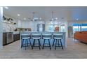 Bright open kitchen with a large island, stainless steel appliances, stylish barstool seating, and modern finishes at 1644 W Thunderbird Rd, Phoenix, AZ 85023