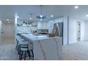 Bright open kitchen with a large island, stainless steel appliances, stylish barstool seating, and modern finishes at 1644 W Thunderbird Rd, Phoenix, AZ 85023
