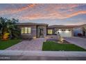 Beautiful desert home exterior at sunset with a welcoming front entrance at 16480 W Catalina Dr, Goodyear, AZ 85395