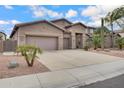 Charming single-story home featuring a three-car garage and desert landscaping with cacti and gravel at 1699 E Hearne Way, Gilbert, AZ 85234