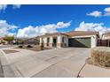 Well-maintained single-story home with desert landscaping and a two-car garage at 18906 E Cattle Dr, Queen Creek, AZ 85142