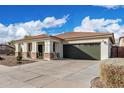 Well-maintained single-story home with desert landscaping and a two-car garage at 18906 E Cattle Dr, Queen Creek, AZ 85142