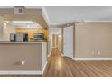 Living room view featuring hardwood floors, tan walls, and an open floor plan at 2025 E Campbell Ave # 140, Phoenix, AZ 85016