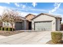Beautiful single-Gathering home features a three-car garage, stone accents, and well-maintained landscaping at 21716 E Waverly Dr, Queen Creek, AZ 85142