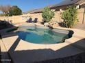 Sparkling swimming pool surrounded by desert landscaping and comfortable lounge chairs for relaxation at 24431 N 38Th Ter, Glendale, AZ 85310