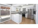 Modern kitchen with island, stainless steel appliances, and white cabinets at 2949 E Willow Ave, Phoenix, AZ 85032