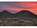 Community view showcasing a clubhouse, pool, and scenic mountain backdrop at 32464 N 134Th Ln, Peoria, AZ 85383