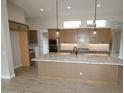 Spacious kitchen featuring a large island with granite countertops and wooden floors at 32464 N 134Th Ln, Peoria, AZ 85383