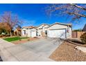House exterior showcasing a two-car garage and manicured lawn at 3332 E Powell Pl, Chandler, AZ 85249