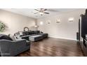 Spacious living room featuring a sectional sofa and hardwood floors at 3332 E Powell Pl, Chandler, AZ 85249