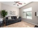 Bright office with a gray sofa, large window, and tile flooring at 3332 E Powell Pl, Chandler, AZ 85249