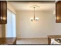 Dining area adjacent to the kitchen with a chandelier at 3840 N 43Rd Ave # 75, Phoenix, AZ 85031