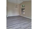 Spacious dining area with gray vinyl flooring and large windows at 4841 S Vista Pl, Chandler, AZ 85248