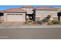 Front view of a two-story house with a three-car garage at 6616 W Side Canyon Trl, Phoenix, AZ 85083
