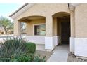 House entrance with covered porch and wrought iron door at 6657 E Regina St, Mesa, AZ 85215