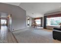 Open dining area with a view to the living room and hallway at 7833 S Terrace Rd, Tempe, AZ 85284