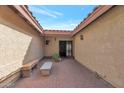 Courtyard entry with brick pavers and a stone bench at 7833 S Terrace Rd, Tempe, AZ 85284