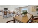 Open concept dining area with wood table and seating for six at 97 S Collier Ln, Casa Grande, AZ 85122