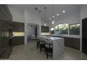 Modern kitchen with dark cabinetry, marble island, and high-end appliances at 10040 N 78Th Pl, Scottsdale, AZ 85258