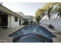 Inviting swimming pool and spa with a tiled border at 10040 N 78Th Pl, Scottsdale, AZ 85258