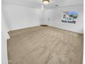Spacious living room with neutral colored carpet and lots of natural light at 12517 W Rosewood Dr, El Mirage, AZ 85335