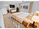 Large main bedroom with a king-size bed, dresser, and backyard view at 12517 W Rosewood Dr, El Mirage, AZ 85335