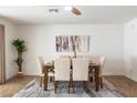 Bright dining room with wood table and neutral colored seating at 12613 W Brandywine Dr, Sun City West, AZ 85375