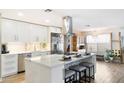 Renovated kitchen with white cabinets, quartz countertops, and an island at 12613 W Brandywine Dr, Sun City West, AZ 85375