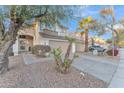 Two-story house with tan exterior, two-car garage, and palm trees at 13638 W Desert Flower Dr, Goodyear, AZ 85395