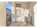 Front entry with decorative security door and welcoming planters at 13638 W Desert Flower Dr, Goodyear, AZ 85395