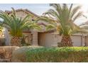 Two-story house with palm trees and well-maintained landscaping at 13829 W Rovey Ave, Litchfield Park, AZ 85340
