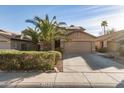 Two-story house with solar panels, palm trees, and a two-car garage at 13829 W Rovey Ave, Litchfield Park, AZ 85340