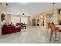 Spacious living room with red leather couches and built-in shelving at 14982 W Gentle Breeze Way, Surprise, AZ 85374