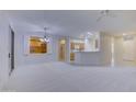 Spacious living room with high ceilings, a chandelier, and built-in shelving at 17733 N Escalante Ln, Surprise, AZ 85374