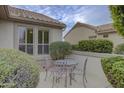 Cozy patio with a metal table and chairs, perfect for outdoor dining at 17733 N Escalante Ln, Surprise, AZ 85374