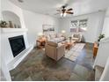 Bright living room featuring a fireplace and tile flooring at 18164 W Smokey Dr, Surprise, AZ 85388
