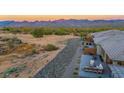 Elevated view of backyard patio, landscaping, and mountain backdrop at 18324 E Spring Valley Ct, Rio Verde, AZ 85263