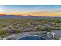Aerial view of homes with mountain views at sunset at 18324 E Spring Valley Ct, Rio Verde, AZ 85263