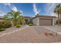 Single-story home with a two-car garage and desert landscaping at 19043 N Aztec Point Dr, Surprise, AZ 85387