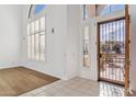 Bright entryway with tiled floors and iron front door at 2380 W Megan St, Chandler, AZ 85224