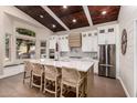 Bright kitchen featuring white cabinets, an island, and a vaulted ceiling at 245 W Sagebrush St, Gilbert, AZ 85233