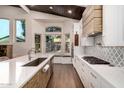 Modern kitchen with stainless steel appliances and a built-in kitchen nook at 245 W Sagebrush St, Gilbert, AZ 85233