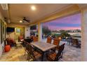 Covered patio with dining table and chairs overlooking the golf course at 27062 W Behrend Dr, Buckeye, AZ 85396